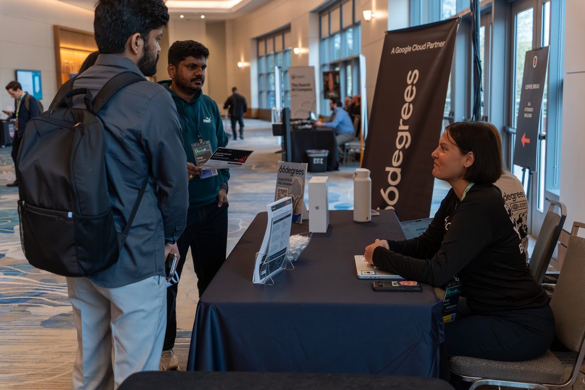 Attendees talking with the 66degrees team at their booth
