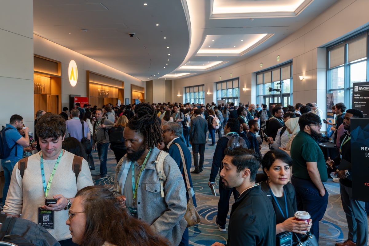 The conference hallway filled with attendees between sessions