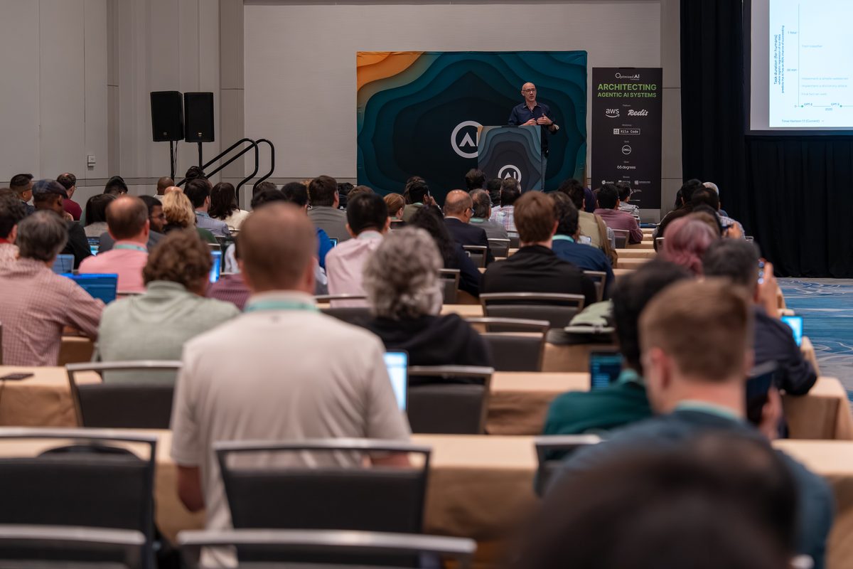 A speaker presenting to a full session room