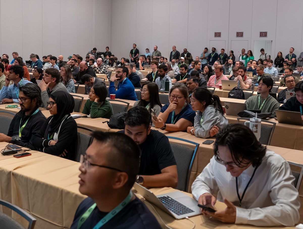 Attendees at long tables during a technical workshop