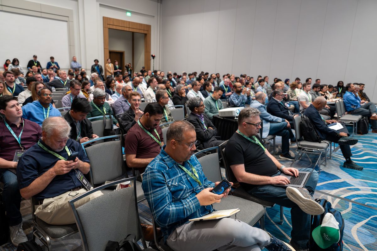 Attendees seated close to the stage in a breakout session